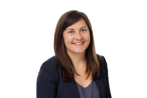 photo of a woman in a dark blazer smiling